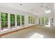 Bright sunroom with large windows and doors, offering natural light and access to the outdoors at 3672 Haddon Hall Rd, Atlanta, GA 30327