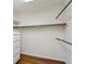 Walk-in closet featuring a white cabinet with drawers, and multiple hanging rods for optimal organization at 3672 Haddon Hall Rd, Atlanta, GA 30327