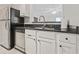 Bright kitchen featuring stainless steel dishwasher and refrigerator adjacent to a pass-through window at 970 Sidney Marcus Ne Blvd # 2403, Atlanta, GA 30324