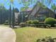 Charming stone and stucco home with lush landscaping and circular driveway on a sunny day at 1173 Jimson Se Cir, Conyers, GA 30013