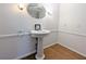 Bright bathroom featuring a pedestal sink and hardwood floors at 1409 Oakridge Cir, Decatur, GA 30033