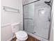 Updated bathroom with marble-tiled shower, glass door, and modern fixtures at 1409 Oakridge Cir, Decatur, GA 30033