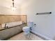 Bathroom featuring a modern soaking tub, a toilet, and neutral tile at 1409 Oakridge Cir, Decatur, GA 30033