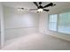 Bedroom with neutral carpet, ceiling fan, track lighting and a window with privacy shades at 1409 Oakridge Cir, Decatur, GA 30033