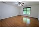 Spacious bedroom with hardwood floors, a ceiling fan, and large window at 1409 Oakridge Cir, Decatur, GA 30033