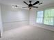 Cozy bedroom with carpeting, a ceiling fan, and a large window overlooking the backyard at 1409 Oakridge Cir, Decatur, GA 30033