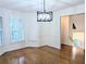 Dining room with hardwood floors, modern light fixture, wainscotting, and bright bay window at 1409 Oakridge Cir, Decatur, GA 30033