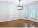 Formal dining room with hardwood floors, a modern chandelier, and bright windows with shutters at 1409 Oakridge Cir, Decatur, GA 30033