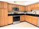 Kitchen showcasing stainless steel appliances, modern countertops, and custom wood cabinetry at 1409 Oakridge Cir, Decatur, GA 30033