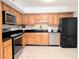 Kitchen showcasing stainless steel appliances, modern countertops, and custom wood cabinetry at 1409 Oakridge Cir, Decatur, GA 30033