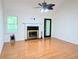 Bright living room with hardwood floors, fireplace, ceiling fan, and a large window with natural light at 1409 Oakridge Cir, Decatur, GA 30033