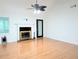 Bright living room with fireplace, ceiling fan, and gleaming hardwood floors at 1409 Oakridge Cir, Decatur, GA 30033