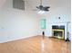 Bright living room features a fireplace, ceiling fan, hardwood floors and large windows at 1409 Oakridge Cir, Decatur, GA 30033