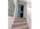 Carpeted stairs with glass block window leading to the upper level at 1409 Oakridge Cir, Decatur, GA 30033