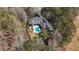 An aerial shot shows the beautiful brick home and pool area with plenty of natural trees surrounding the property at 850 Cog Hl, Mcdonough, GA 30253
