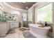 Bright bathroom featuring a walk-in shower, soaking tub, neutral walls, and tile flooring at 850 Cog Hl, Mcdonough, GA 30253