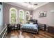 Bedroom with hardwood floors, three large windows, and neutral color walls at 850 Cog Hl, Mcdonough, GA 30253