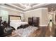 Comfortable bedroom with a tray ceiling, hardwood floors, and plenty of natural light at 850 Cog Hl, Mcdonough, GA 30253