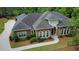 The front exterior of the home is brick with white accents on the entryway and coordinating landscaping at 850 Cog Hl, Mcdonough, GA 30253