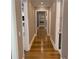 Long hallway with hardwood floors featuring white trim and neutral walls at 850 Cog Hl, Mcdonough, GA 30253