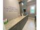 Bright laundry room featuring lots of counter space, storage, gray cabinets, and tiled floors at 850 Cog Hl, Mcdonough, GA 30253