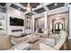 The living room has a coffered ceiling, stone accent wall with a fireplace, neutral furniture, and hardwood flooring at 850 Cog Hl, Mcdonough, GA 30253