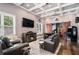 Spacious living room includes a fireplace, coffered ceilings, hardwood floors, and an arcade game at 850 Cog Hl, Mcdonough, GA 30253