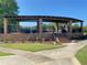 Brick outdoor structure with a covered seating area overlooking the landscaped grounds at 850 Cog Hl, Mcdonough, GA 30253
