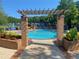 Inviting community pool area with brick structures, lush landscaping, and comfortable seating areas at 850 Cog Hl, Mcdonough, GA 30253