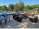 An outdoor lounge area with a brick fire pit and comfortable seating near the community pool at 850 Cog Hl, Mcdonough, GA 30253