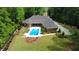 Aerial view of the beautiful backyard featuring a large swimming pool with patio furniture and well manicured landscaping at 850 Cog Hl, Mcdonough, GA 30253