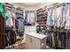 Organized walk-in closet with custom shelving and storage for clothes, shoes and accessories at 850 Cog Hl, Mcdonough, GA 30253
