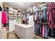 Spacious walk-in closet with custom shelving and storage space, and a center island at 850 Cog Hl, Mcdonough, GA 30253