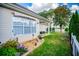 Serene backyard with a manicured lawn, stone landscaping, white picket fence, and covered patio at 2752 Nautical Way, Villa Rica, GA 30180