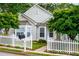 Inviting home featuring a neatly maintained lawn, a classic white picket fence, and lush surrounding greenery at 2752 Nautical Way, Villa Rica, GA 30180