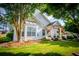 Charming one-story home with well-manicured lawn, lush trees, and a welcoming covered porch at 2752 Nautical Way, Villa Rica, GA 30180