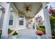 Inviting covered front porch with ceiling fan, decorative plants, and neutral-colored exterior at 2752 Nautical Way, Villa Rica, GA 30180