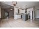 Open kitchen with stainless steel appliances, tile backsplash, gray island, and wood flooring at 2752 Nautical Way, Villa Rica, GA 30180