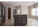 Well lit kitchen with a gray kitchen island and stainless steel appliances at 2752 Nautical Way, Villa Rica, GA 30180