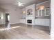 Comfortable living room featuring a fireplace, built-in cabinets, and hardwood floors at 2752 Nautical Way, Villa Rica, GA 30180