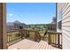 A wooden backyard deck with a railing and steps leading to the yard at 4800 Gablestone Xing, Hoschton, GA 30548