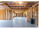 Unfinished basement with framed walls, insulation, and concrete floor, ready to be transformed at 4800 Gablestone Xing, Hoschton, GA 30548