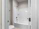 Bathroom with white tub and shower, perfect for unwinding after a long day at 4800 Gablestone Xing, Hoschton, GA 30548