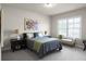 Bright bedroom with a window seat, and large painting on the wall for comfort at 4800 Gablestone Xing, Hoschton, GA 30548