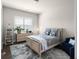 A cozy bedroom featuring a full bed, window with blinds, and a gray and white rug at 4800 Gablestone Xing, Hoschton, GA 30548