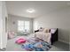 Bright bedroom with neutral walls and carpet features a daybed, plush rug, and table with chairs at 4800 Gablestone Xing, Hoschton, GA 30548