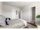 Bedroom featuring a patterned bedspread, a window, and doorways to adjacent rooms at 4800 Gablestone Xing, Hoschton, GA 30548