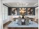 Formal dining room featuring a coffered ceiling, stylish lighting, and sophisticated decor at 4800 Gablestone Xing, Hoschton, GA 30548