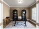 Cozy home office with ample natural light, a sleek desk, and elegant storage at 4800 Gablestone Xing, Hoschton, GA 30548