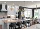 Open-concept kitchen featuring granite island, white cabinetry, and stainless steel appliances at 4800 Gablestone Xing, Hoschton, GA 30548